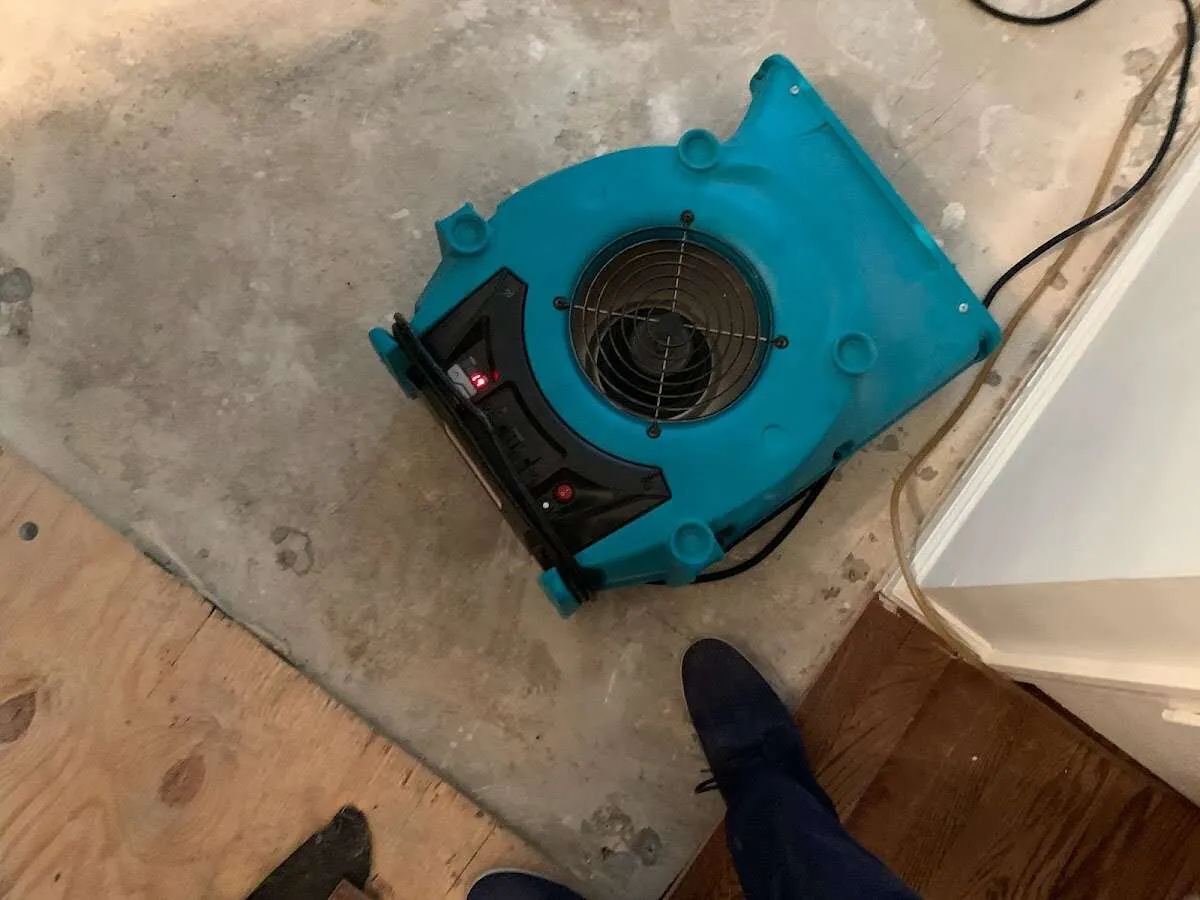Air mover drying subfloor during Commercial Water Damage Restoration in Burlington